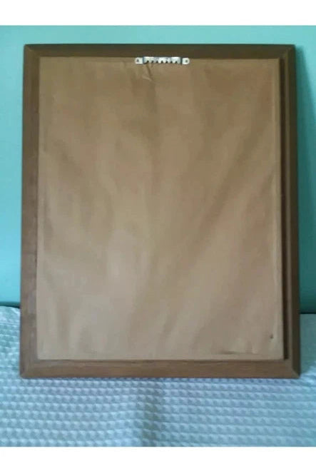 Brown backing of hanging portrat with branding on a textured surface