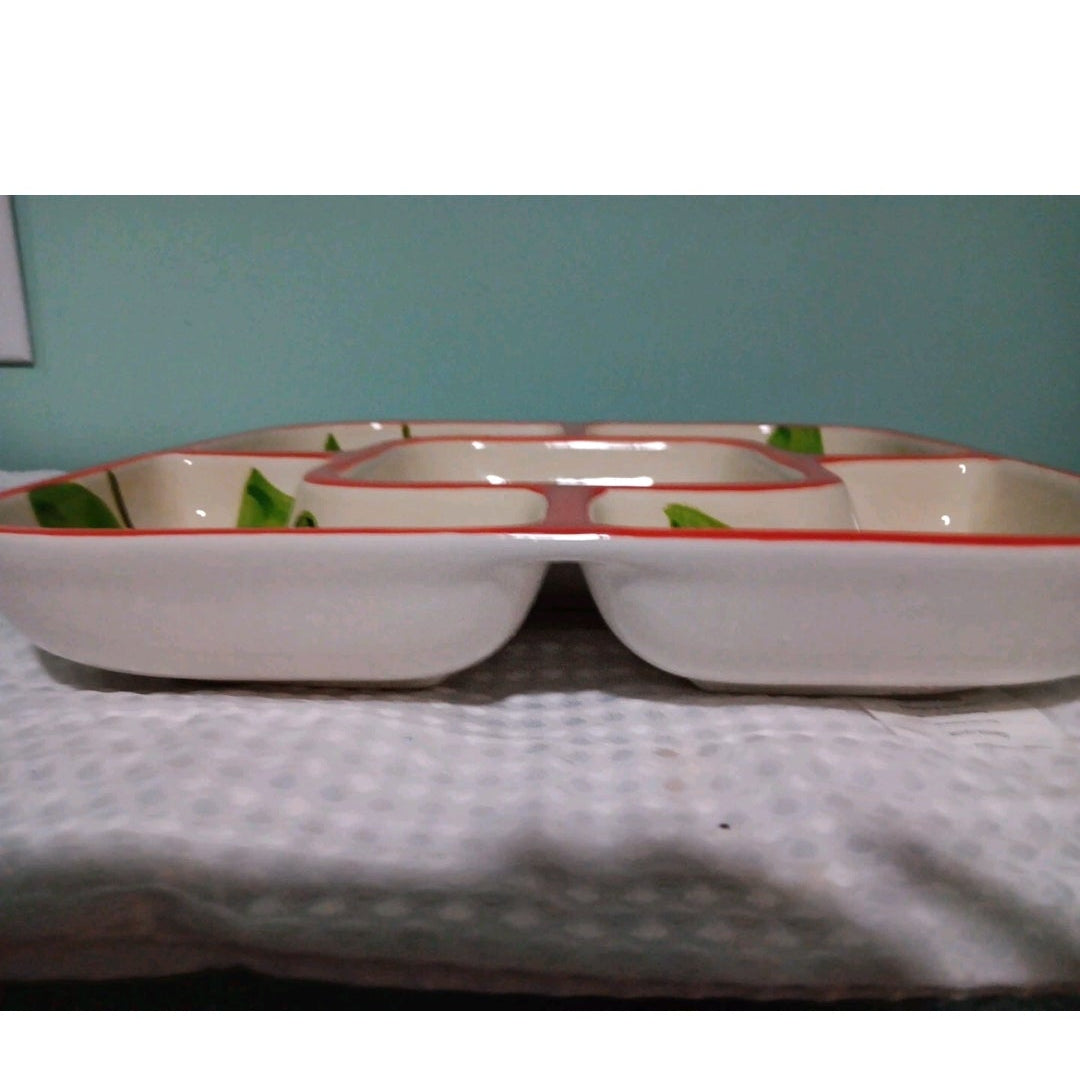 Rectangular ceramic dish with red rim on a textured surface