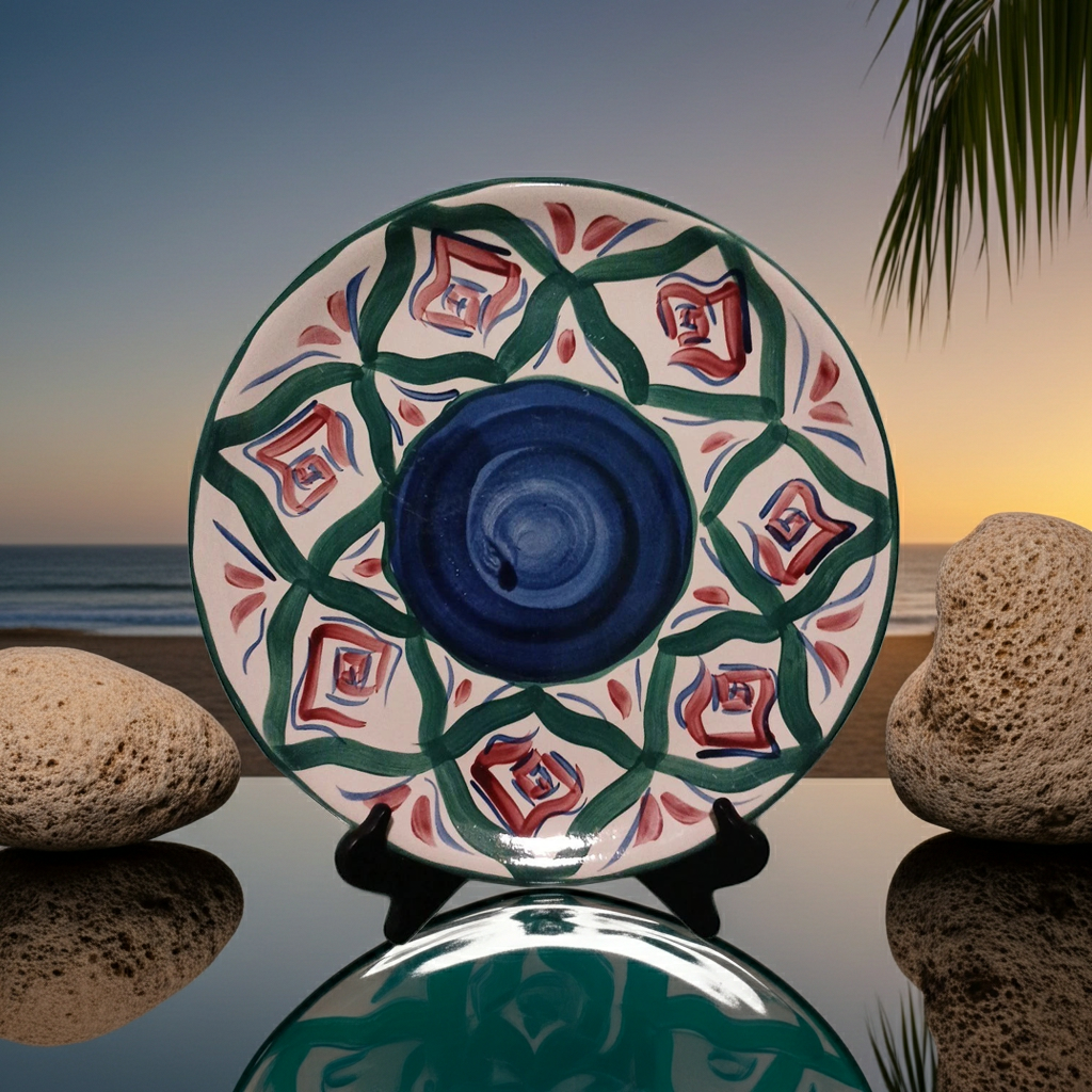 Decorative ceramic plate with geometric pattern on a reflective surface with a sunset background.