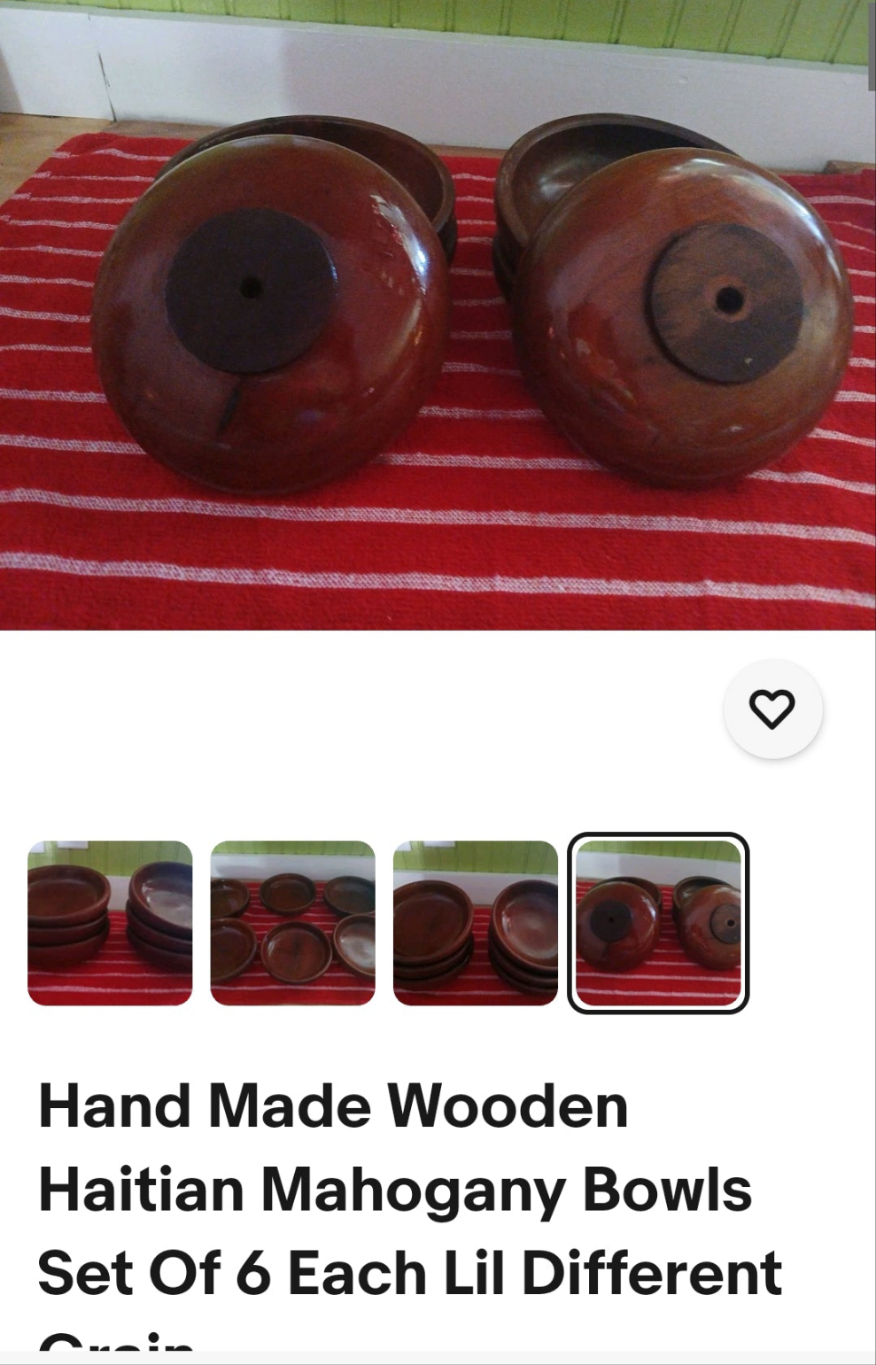 Set of six hand-made wooden Haitian mahogany bowls on a red and white striped surface.