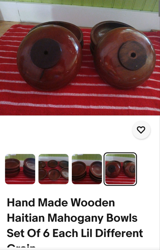 Set of six hand-made wooden Haitian mahogany bowls on a red and white striped surface.