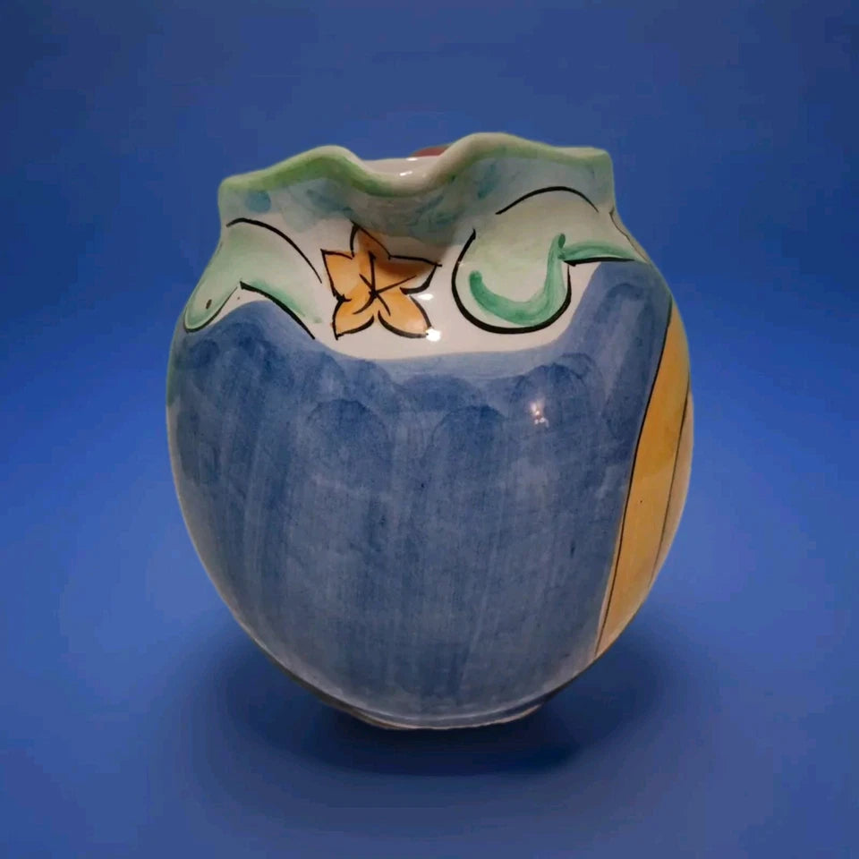 Ceramic vase with decorative elements on a blue background