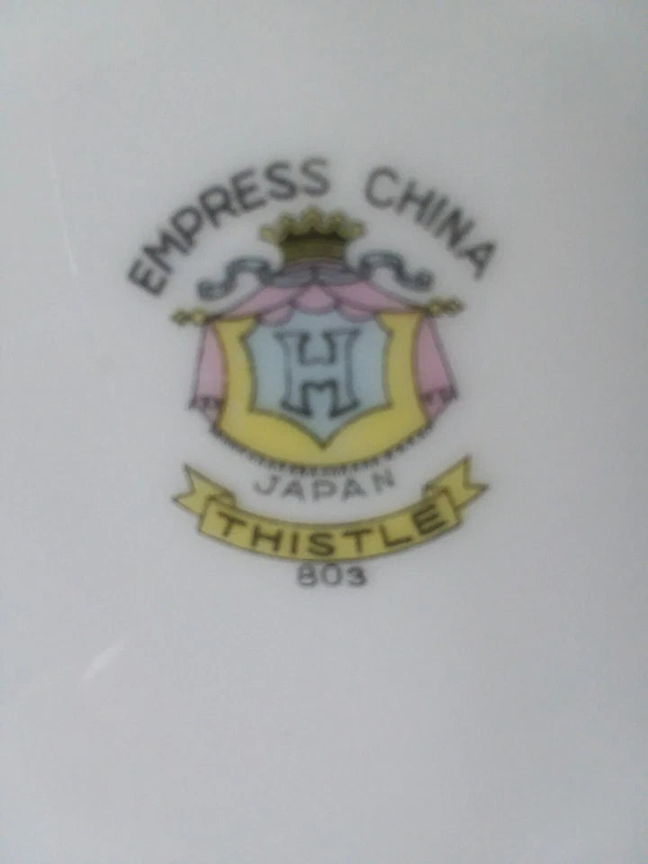 Embossed logo of Empress China with 'Japan' and 'Thistle' text on a white background