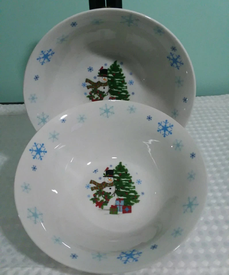 Two ceramic bowls with Christmas-themed designs on a light blue background.