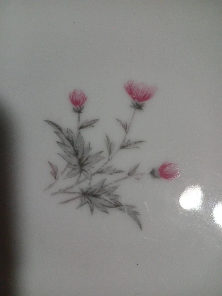 Decorative design of pink flowers and green leaves on a white background