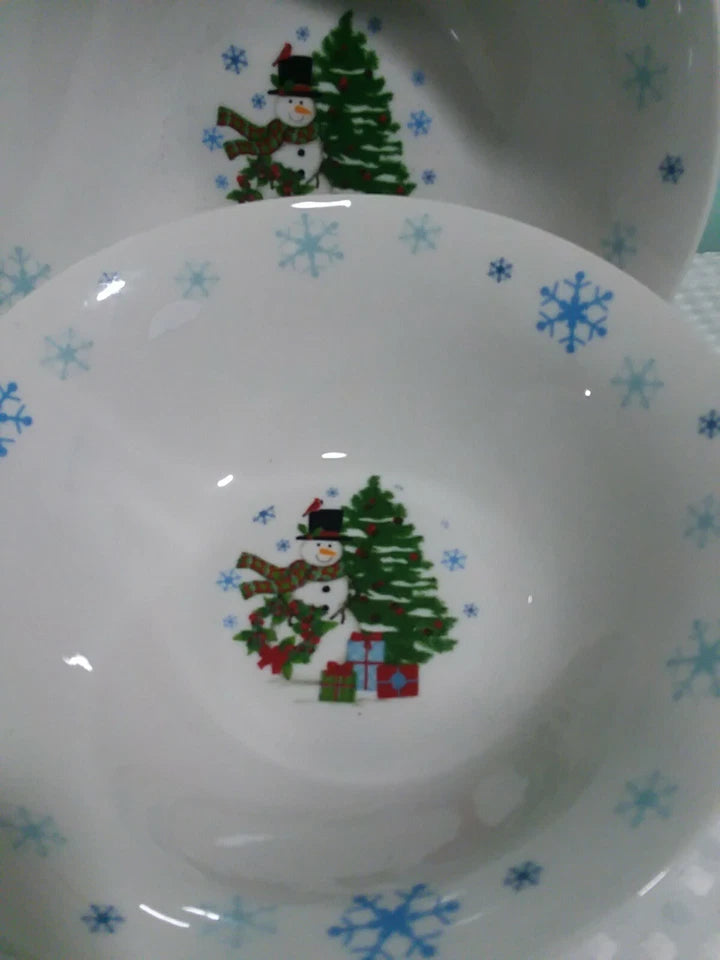 Decorative plate with Christmas-themed design featuring snowmen and trees on a white background.