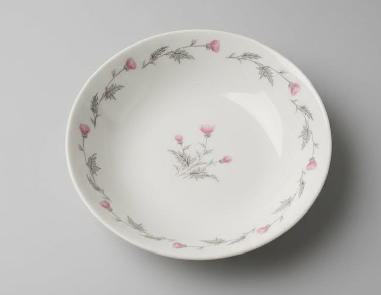 Ceramic plate with floral design on a textured white background
