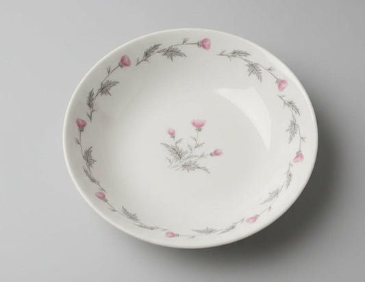 Ceramic plate with floral design on a textured white background