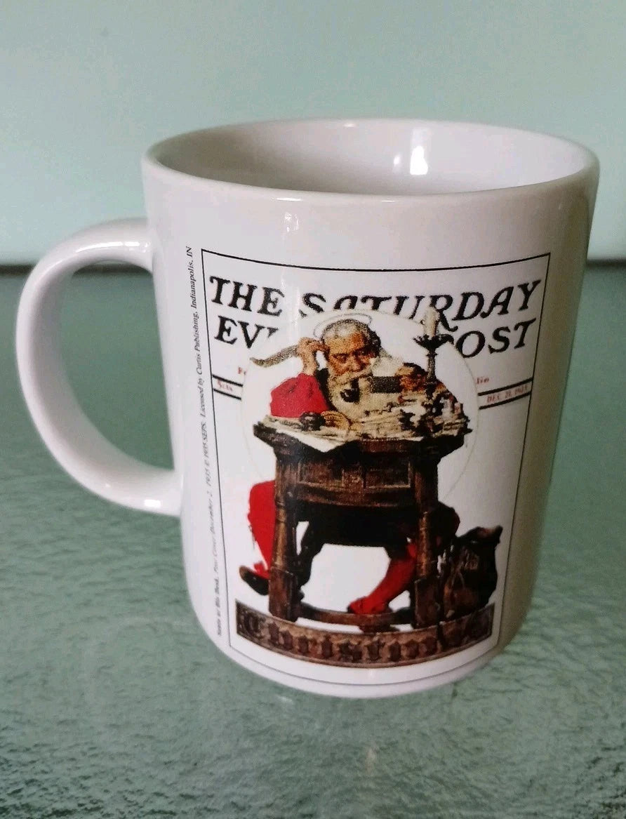 White mug with 'The Saturday Evening Post' graphic on a green surface