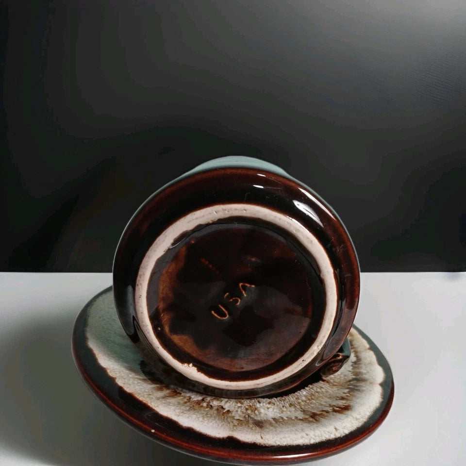 Brown ceramic dish with 'USA' text on a white surface against a dark background
