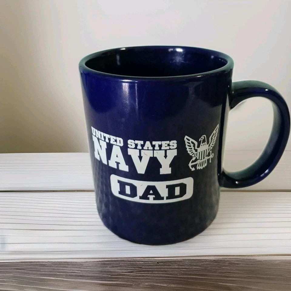 Navy blue mug with 'United States Navy Dad' text on a wooden surface