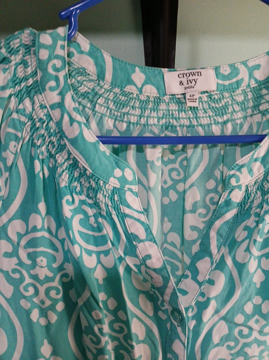Teal and white patterned garment on a hanger with 'crown & ivy' label.