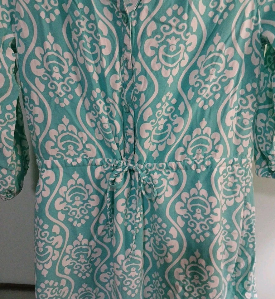 Teal and white patterned garment on a plain background