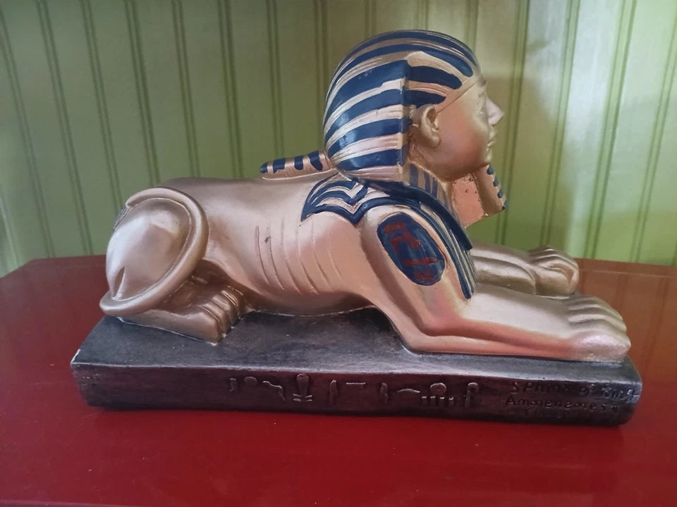 Statue of a lion with Pharaoh head on a red surface
