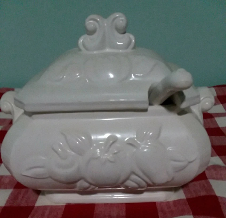 White ceramic jar with lid on a red and white checkered tablecloth