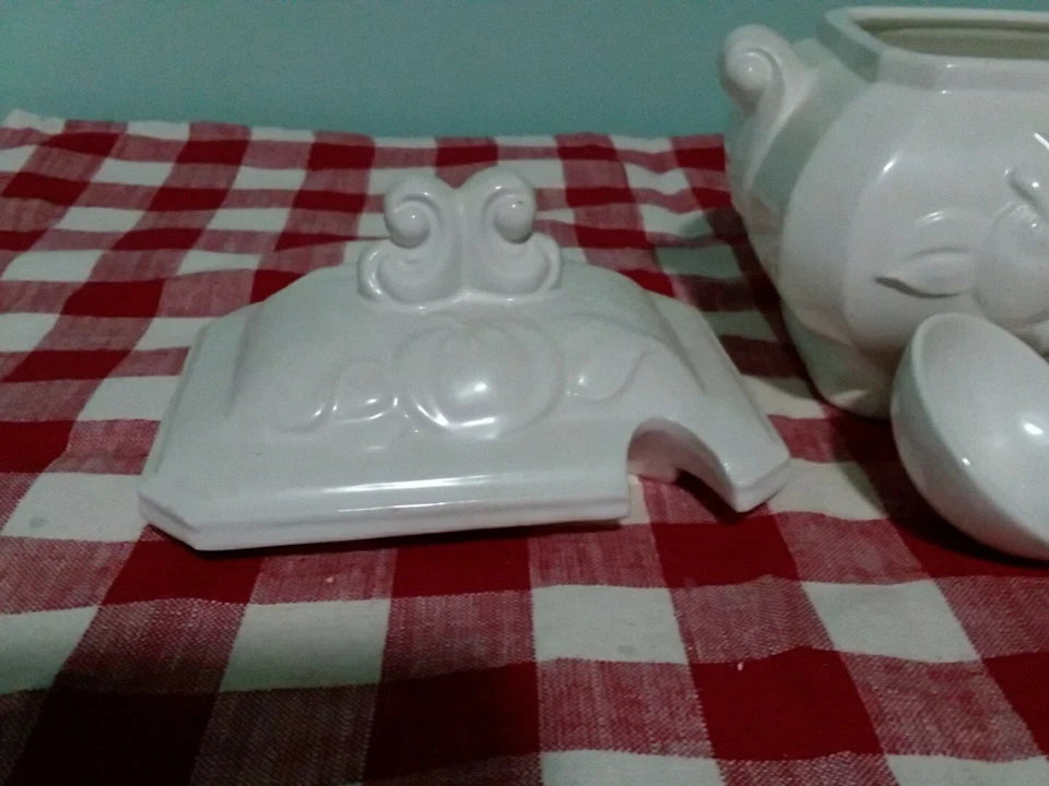 White ceramic item on a red and white checkered tablecloth