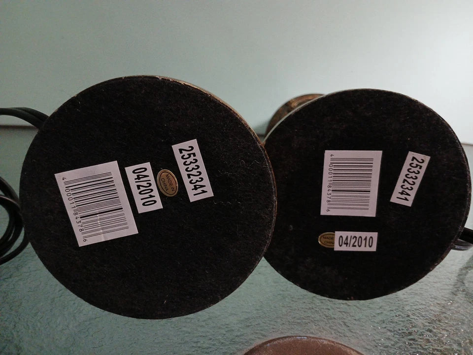 Two black circular objects with labels on a light gray background