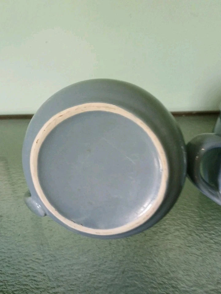 Close-up of a ceramic cup with a green background