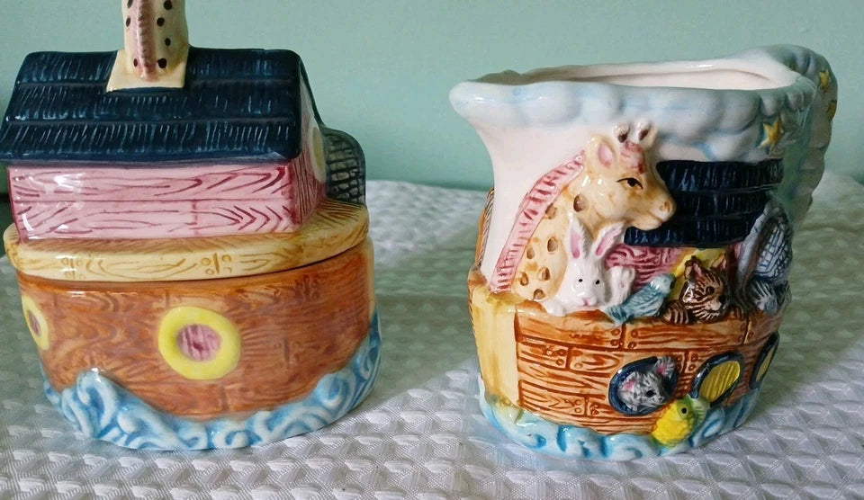Two ceramic containers with decorative designs on a textured surface.
