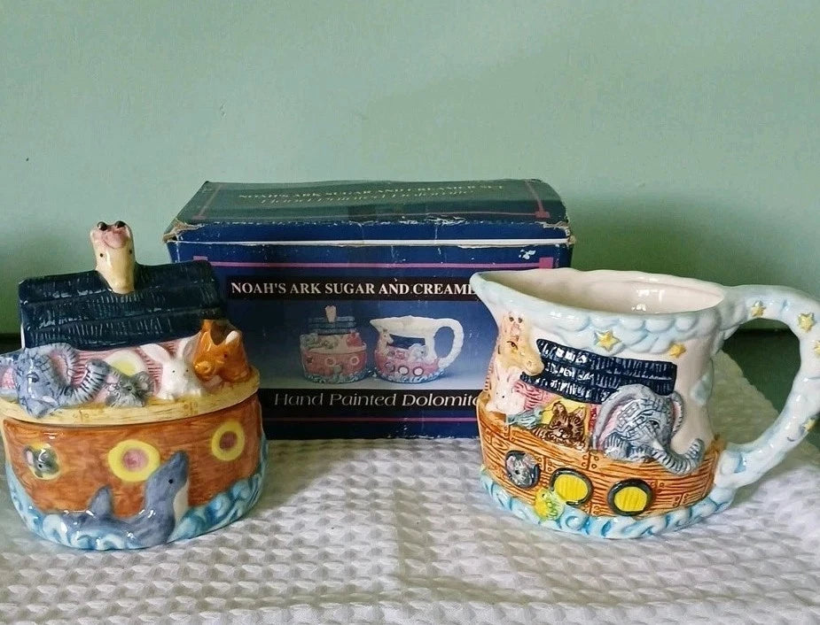 Noah's Ark-themed sugar and creamer set with a matching mug on a light surface.