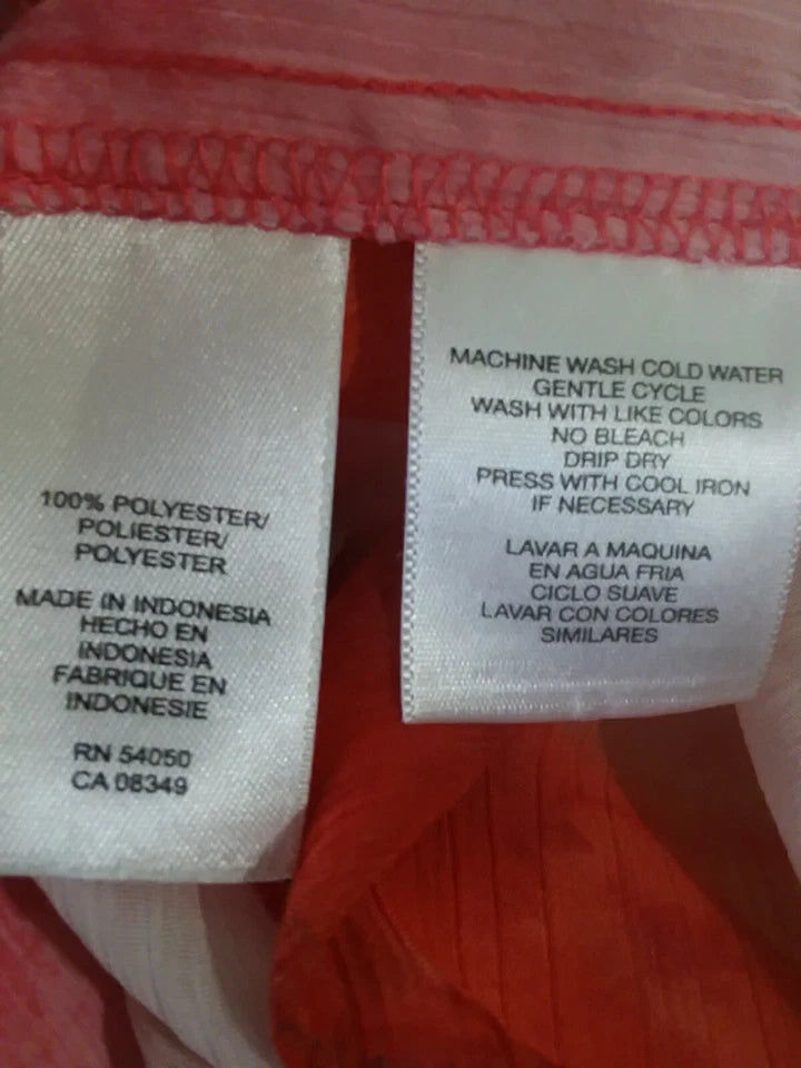 Close-up of fabric tags with washing instructions and material information.