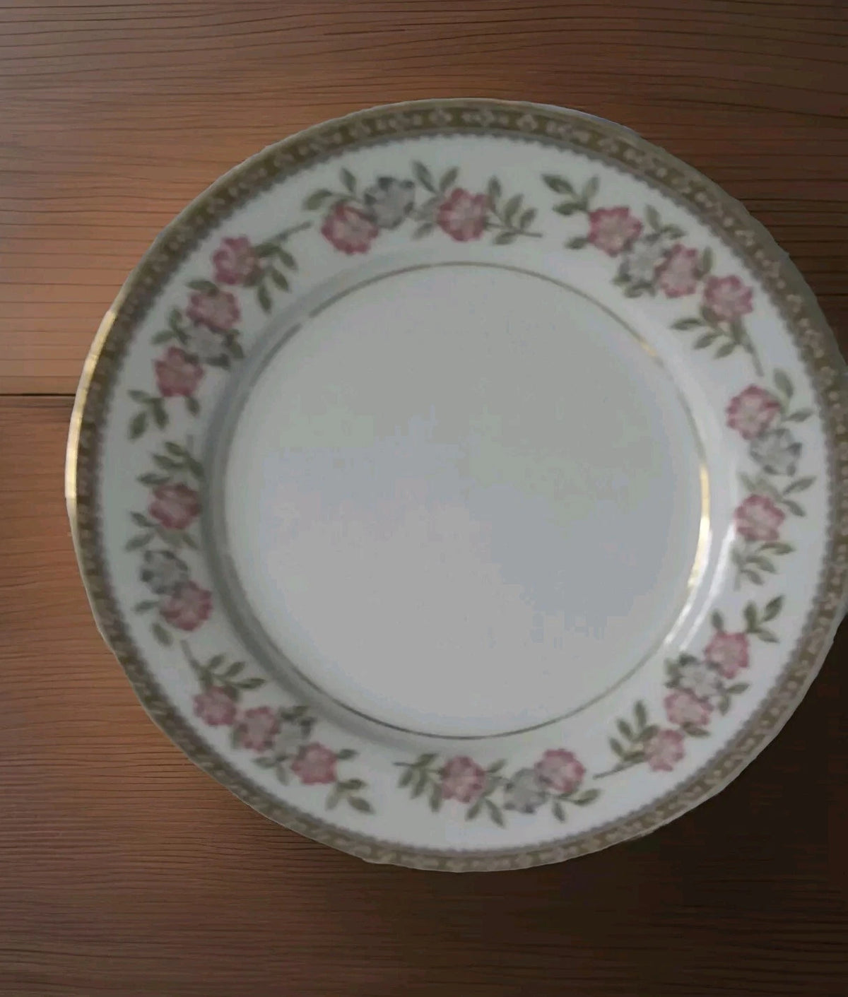 Decorative plate with floral pattern on a wooden surface