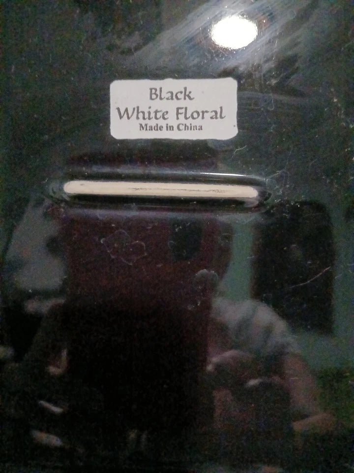 Close-up of a product with a label indicating 'Black White Floral Made in China' on a reflective surface.