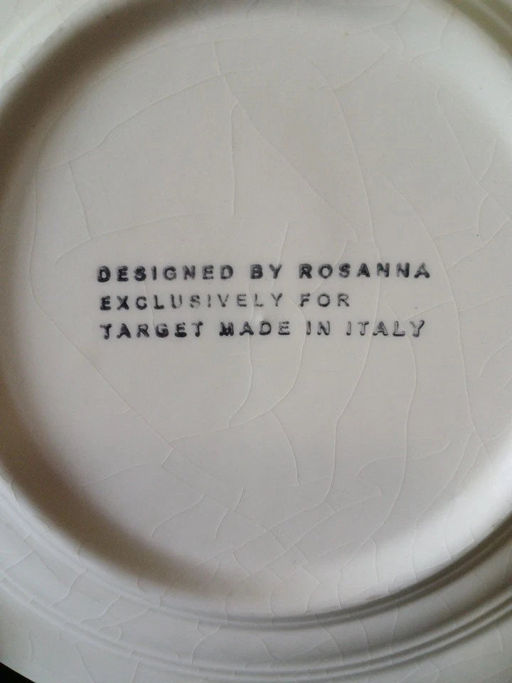 White ceramic plate with text 'Designed by Rosanna Exclusively for Target Made in Italy' on a white background