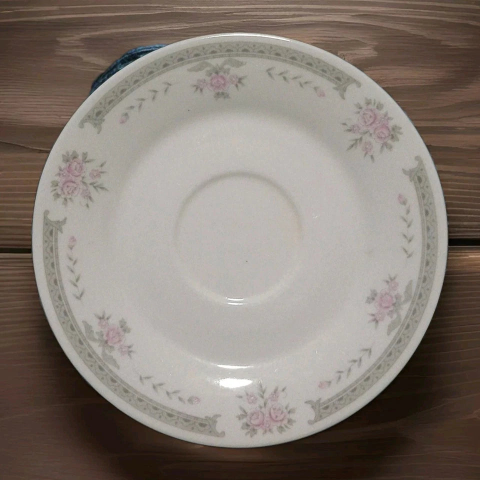 White ceramic plate with floral patterns on a wooden surface