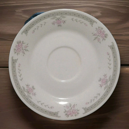 White ceramic plate with floral patterns on a wooden surface