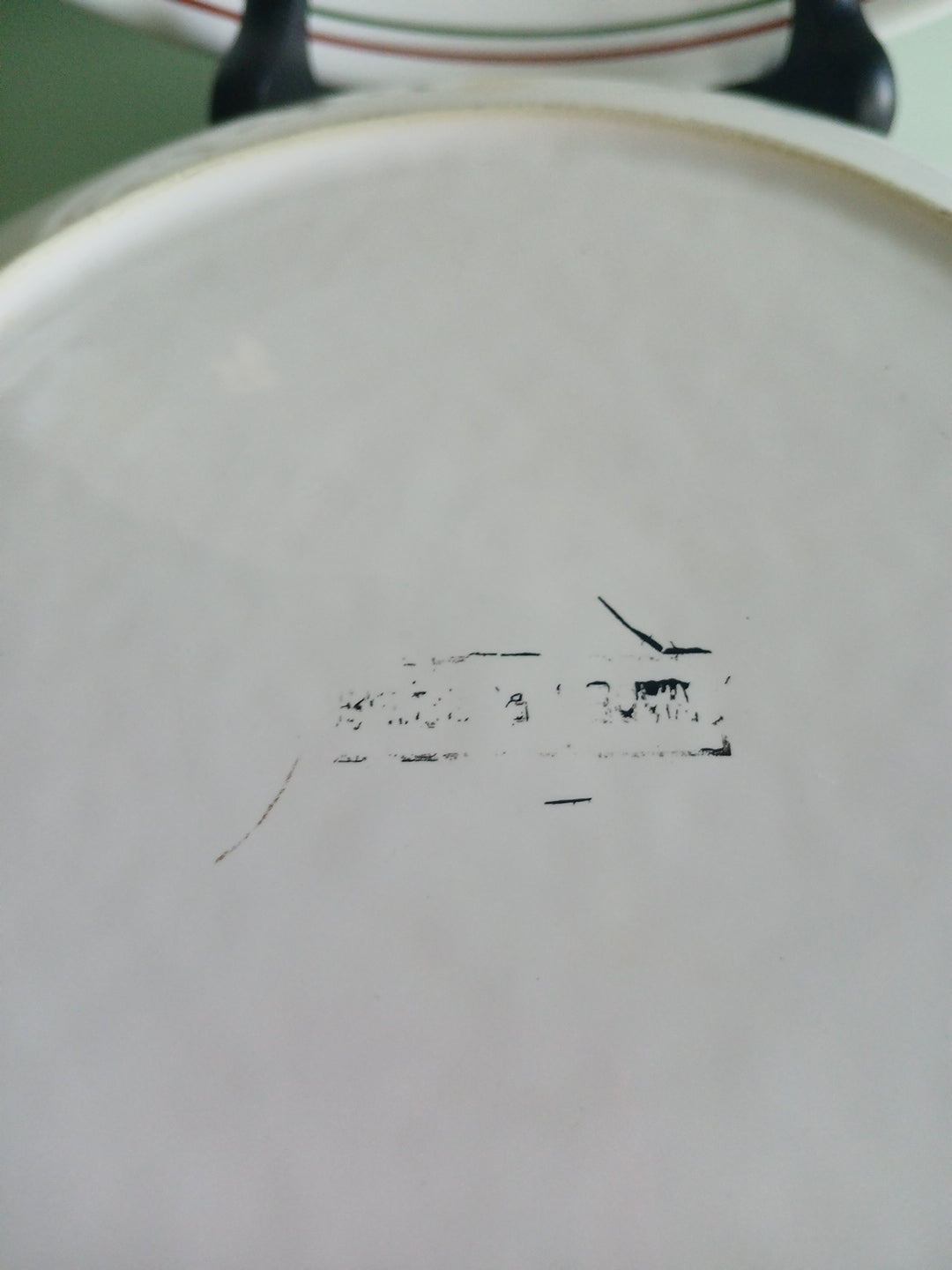 Close-up of a ceramic dish with text on a plain background