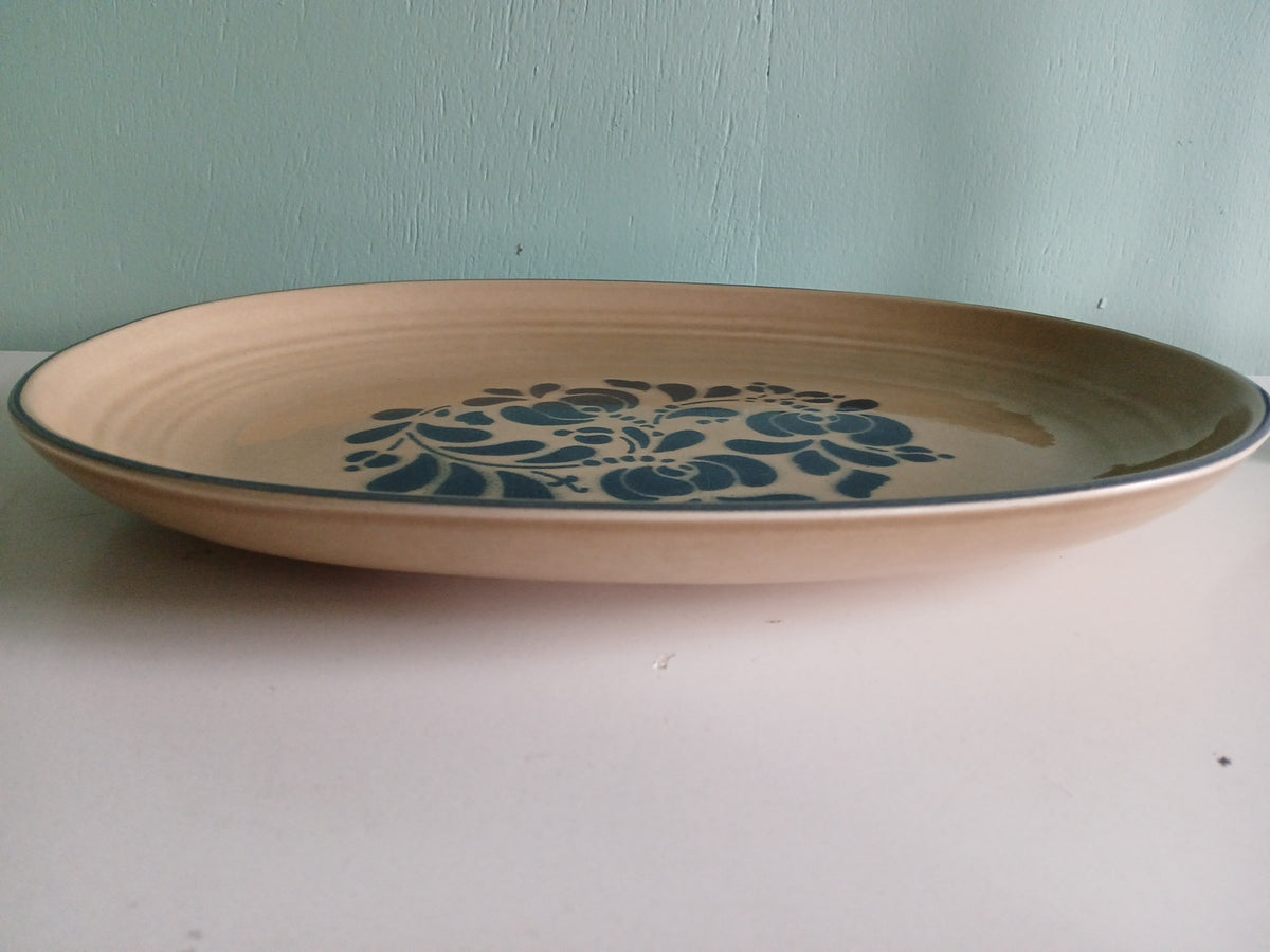 Ceramic plate with blue floral design on a plain background