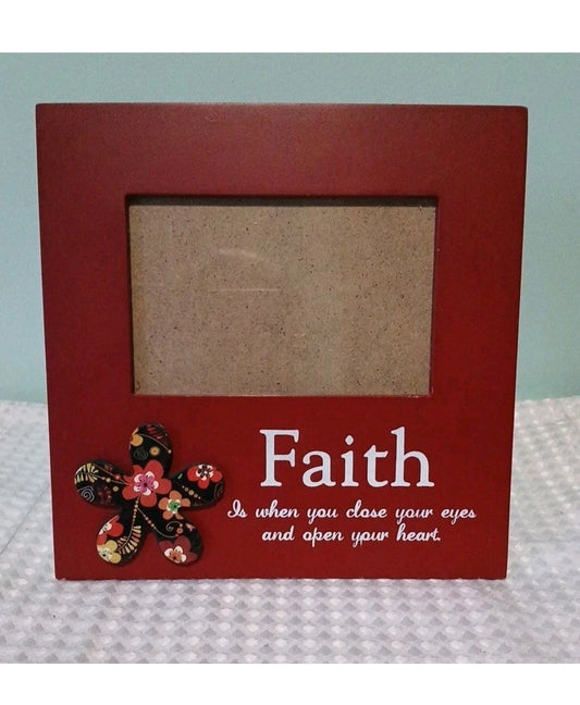 Red picture frame with floral  design and 'Faith' quote on a light blue background