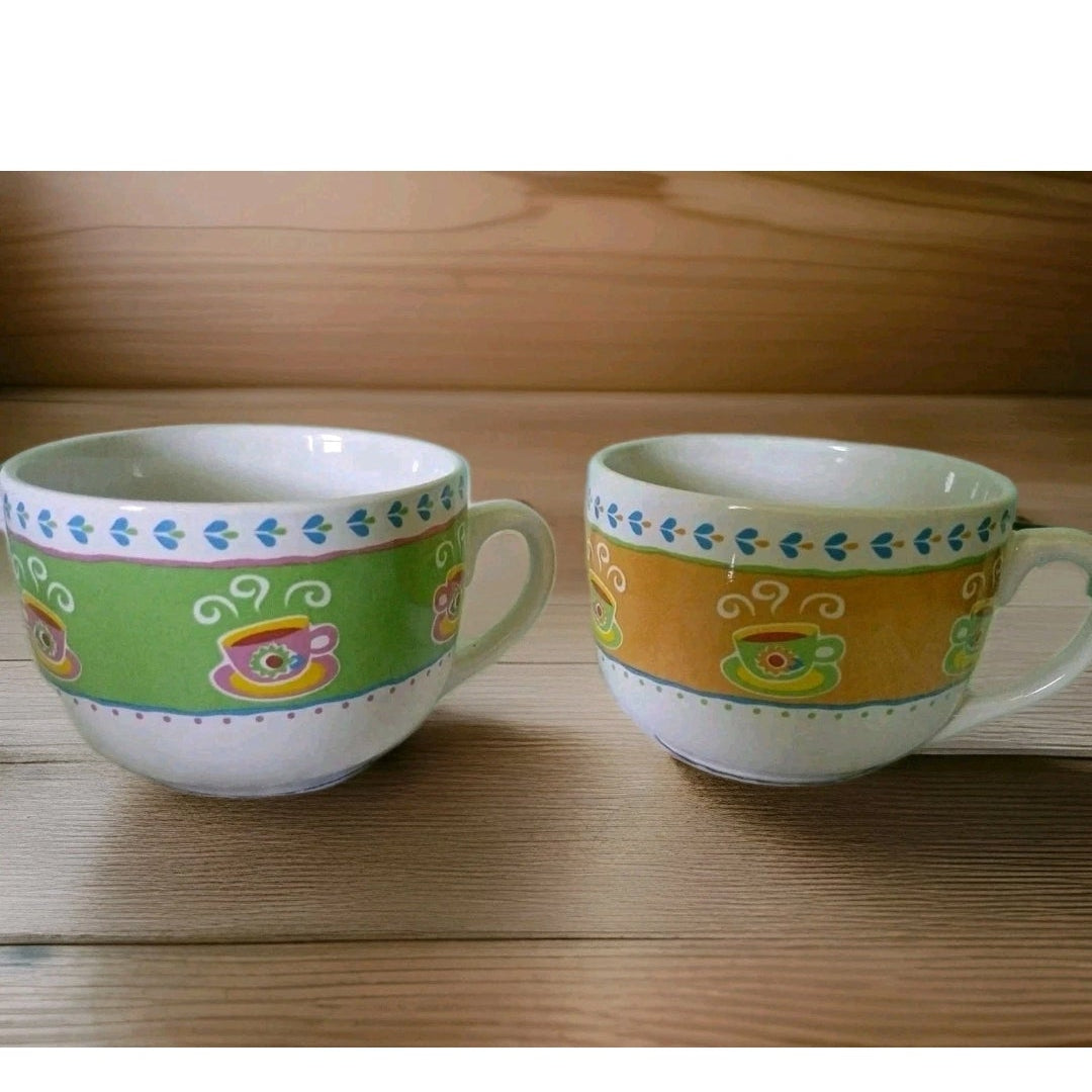 Two colorful ceramic cups on a wooden surface