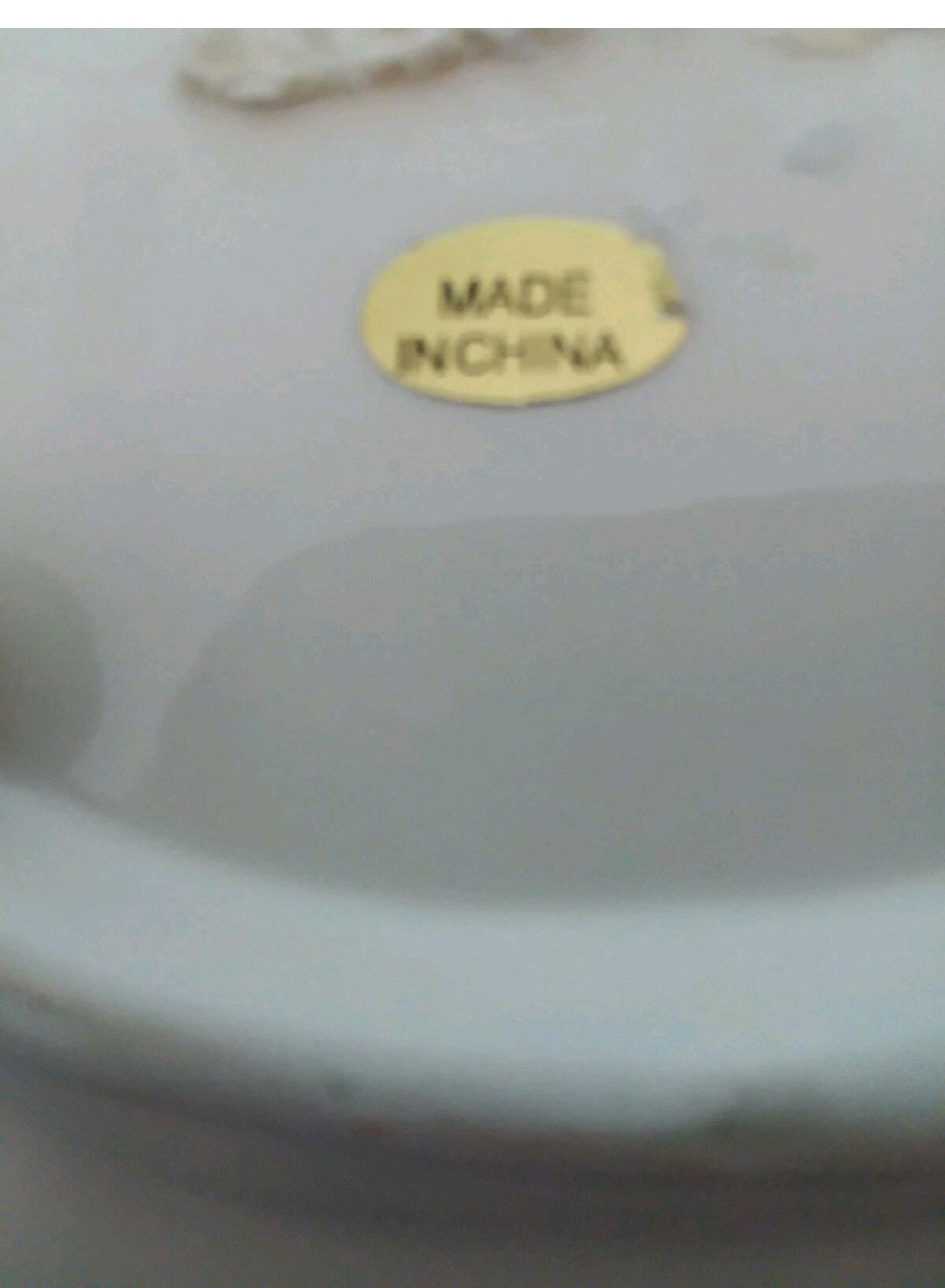 Close-up of a ceramic item with 'MADE IN CHINA' label on a white background