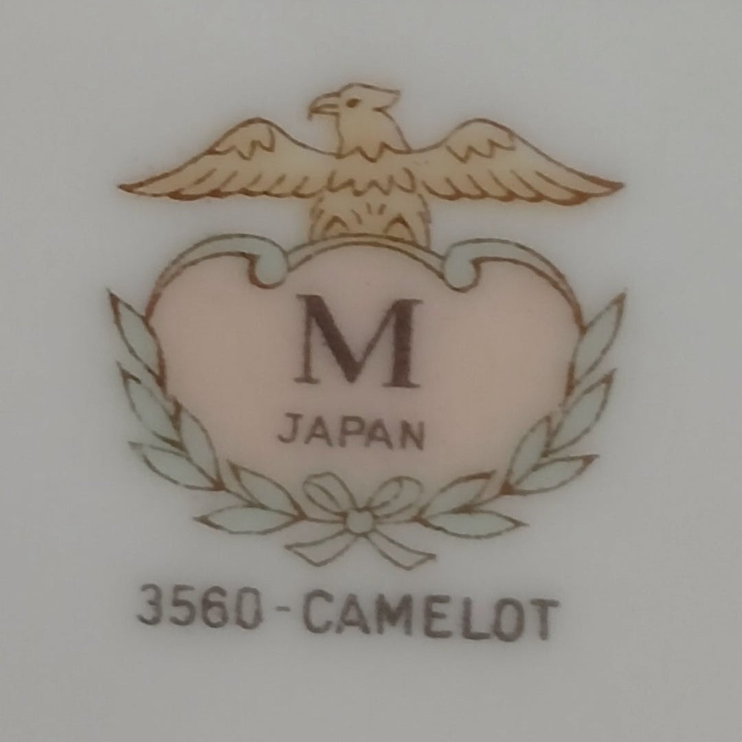 Logo with an eagle and 'M Japan' text on a light background