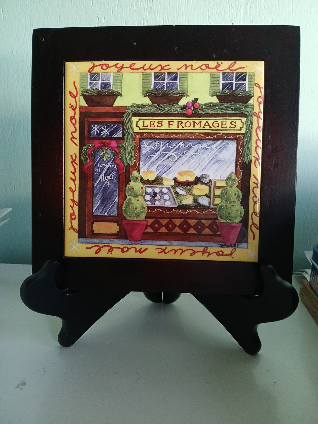 Decorative framed trivet with colorful design on a white background