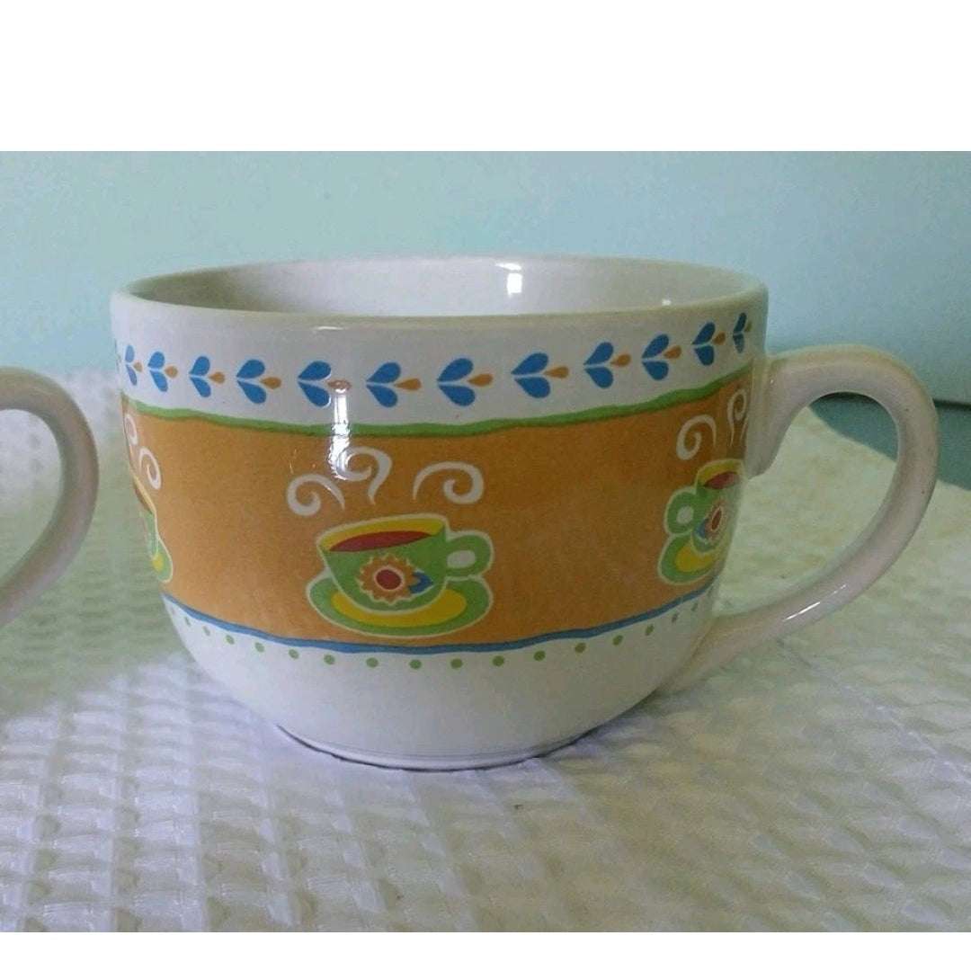 Decorative ceramic mug with colorful patterns on a light green surface.