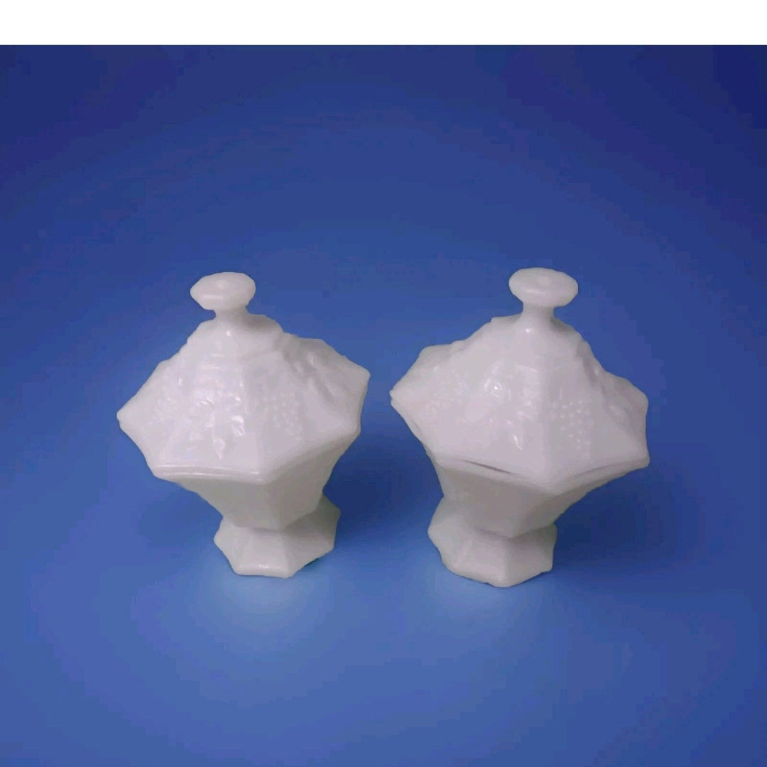 Two white ceramic covered dishes on a blue background