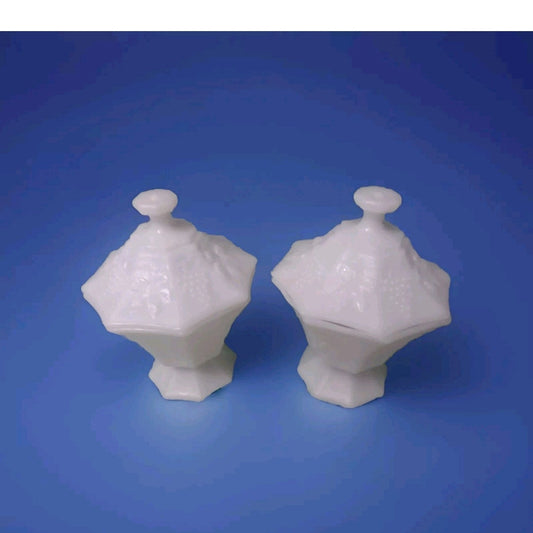 Two white ceramic covered dishes on a blue background