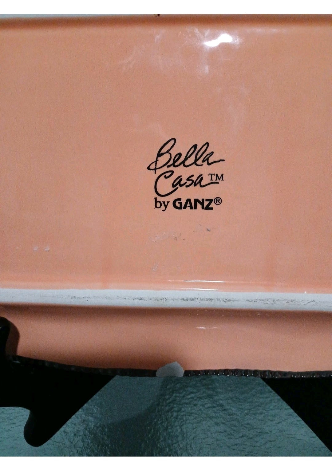 Close-up of a pink container with 'Belle Casa by GANZ' branding.