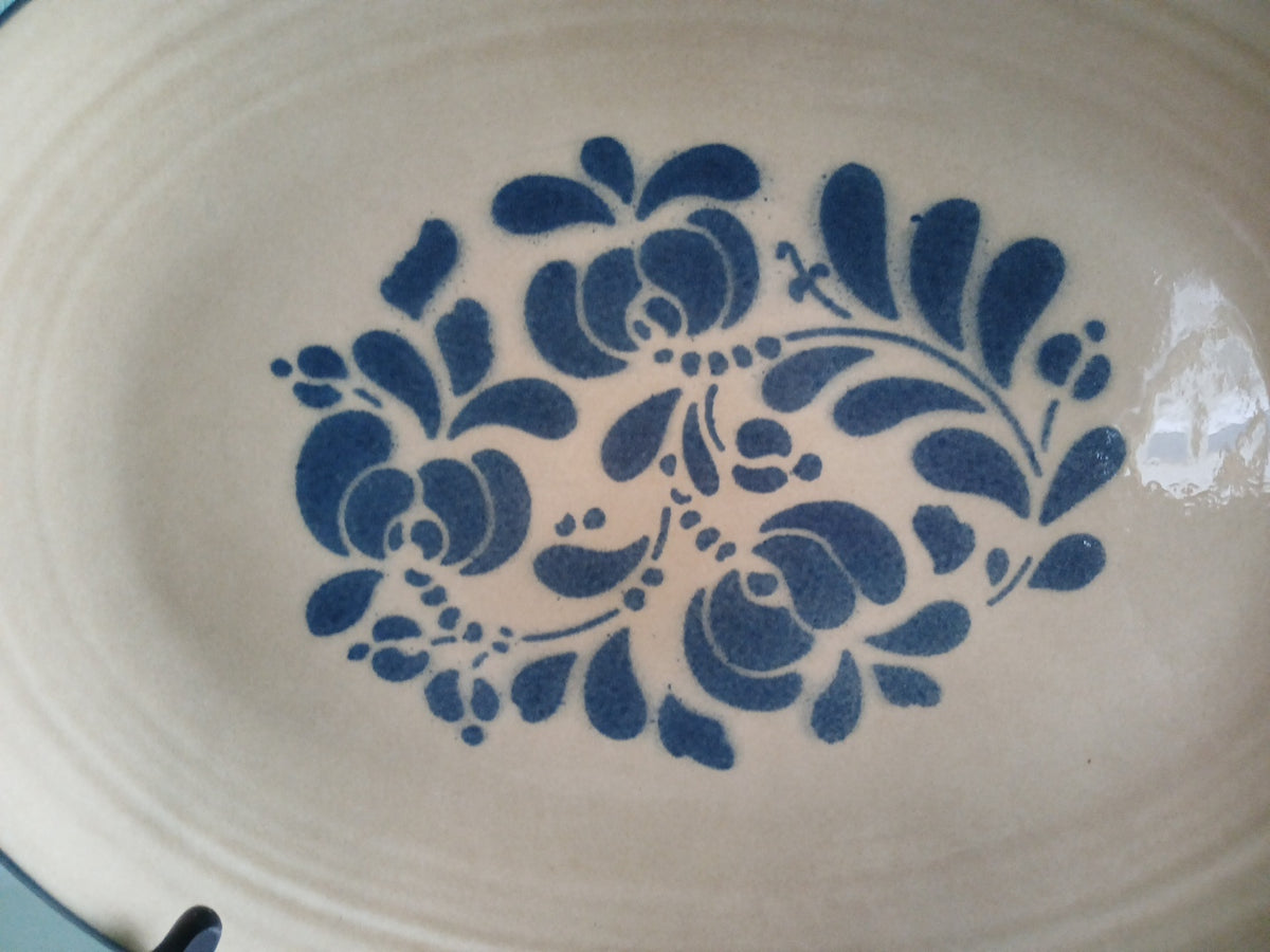 Decorative blue floral pattern on a beige ceramic plate