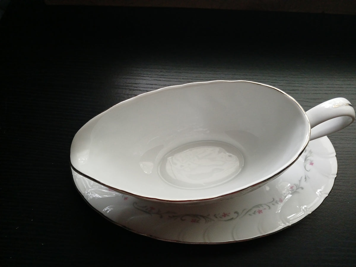 White ceramic bowl with floral patterns on a dark surface