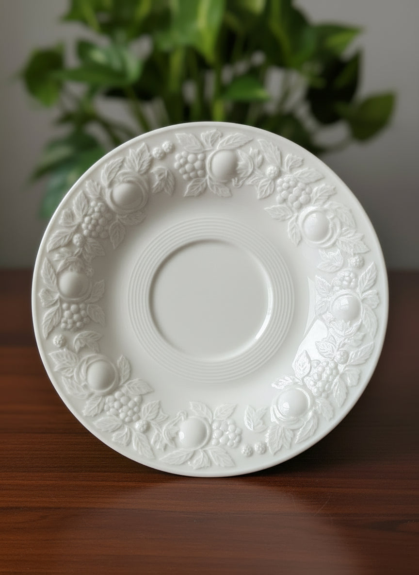 Close-up of a white ceramic saucer on a textured surface