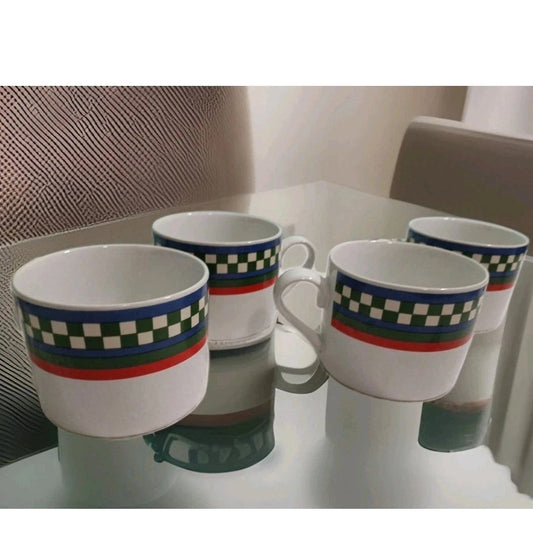 Four mugs with checkered patterns on a reflective surface