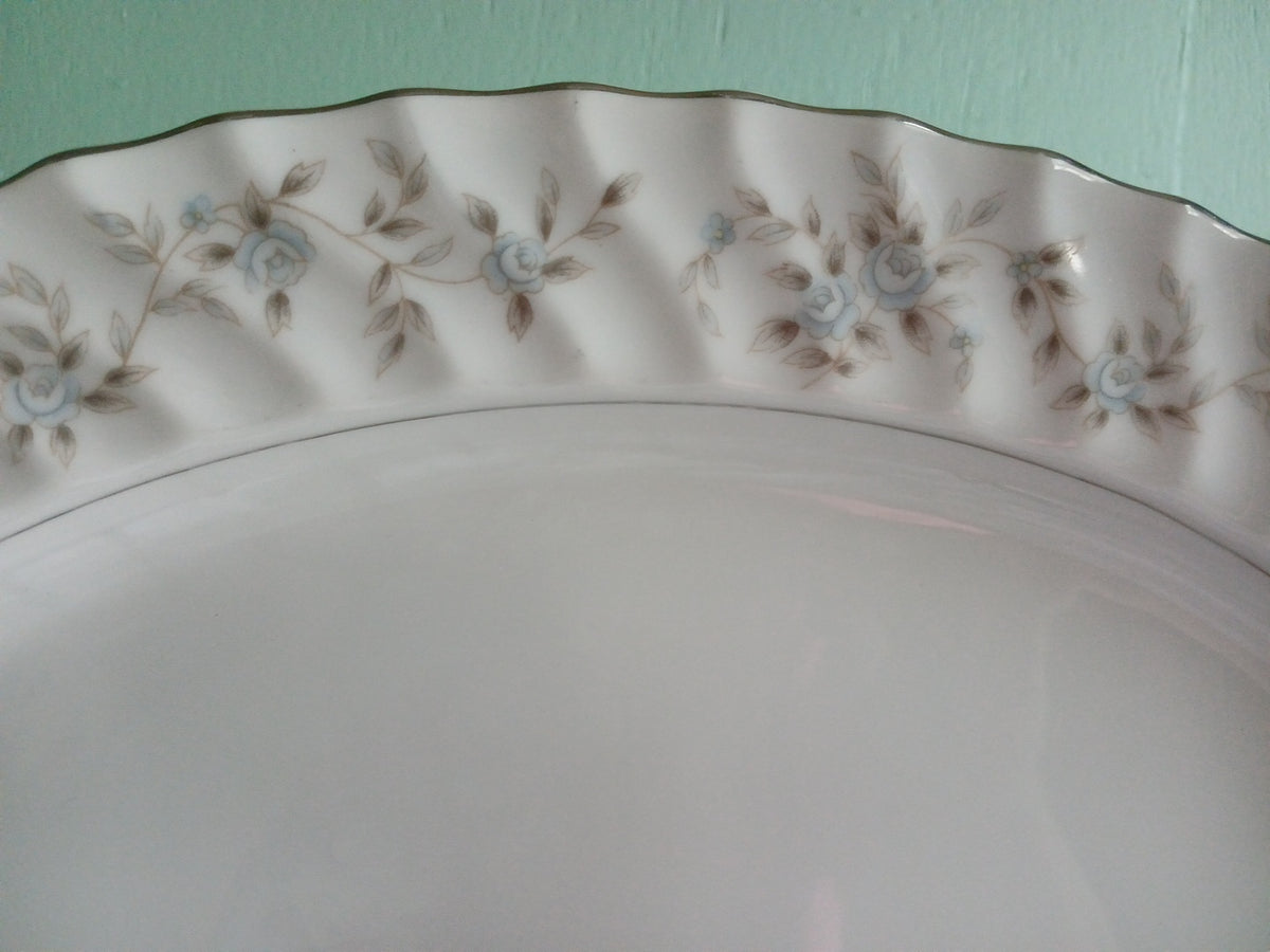 Decorative ceramic plate with floral patterns on a light green background