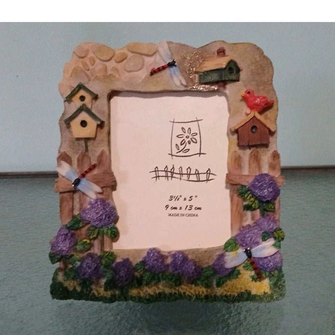 Decorative picture frame with a house design on a gray surface