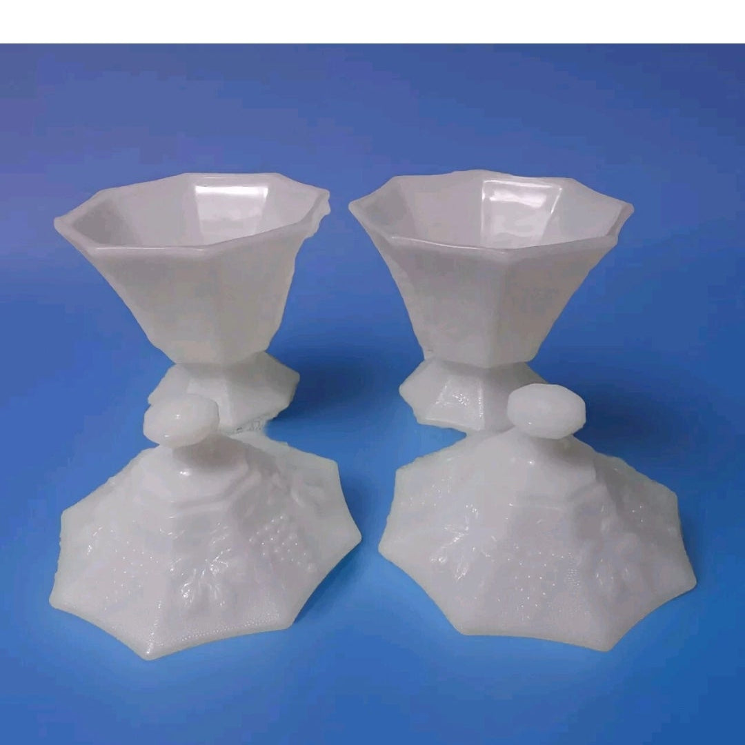 two white candy dishes with lids on a blue background 