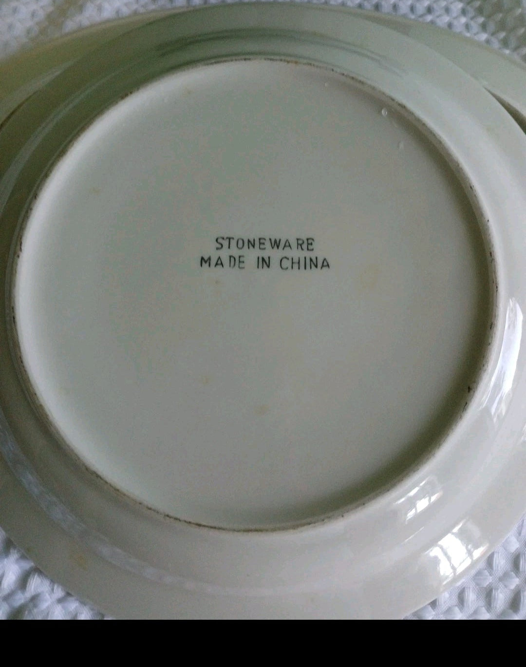Stoneware plate with 'Made in China' text on a textured surface