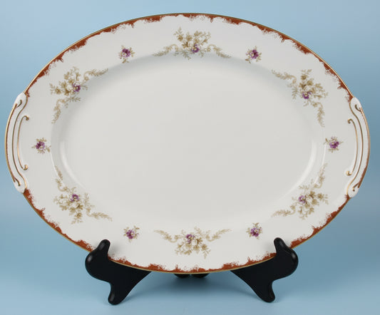 Decorative plate with a floral rim on a stand